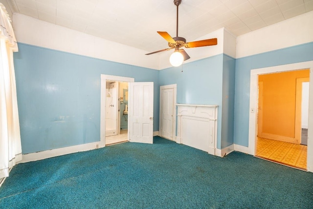 unfurnished bedroom with ceiling fan, vaulted ceiling, carpet flooring, and baseboards