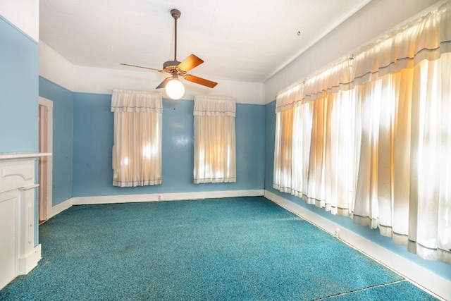 spare room featuring a ceiling fan, carpet, and baseboards