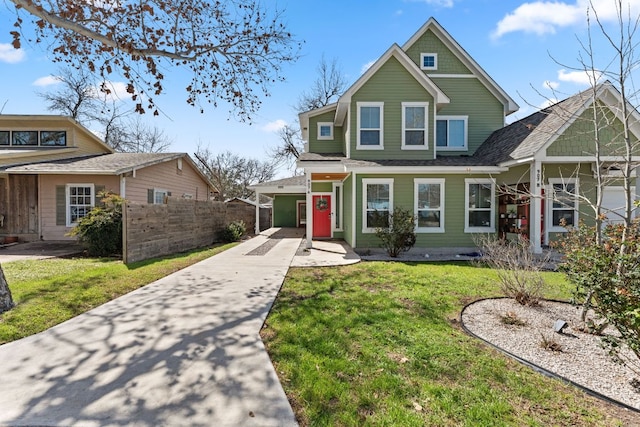 view of front of property featuring concrete driveway, a front yard, and fence