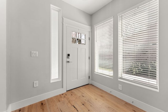 entrance foyer with light wood-type flooring and baseboards