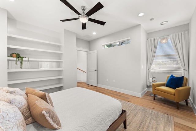 bedroom featuring ceiling fan, recessed lighting, light wood-style flooring, and baseboards