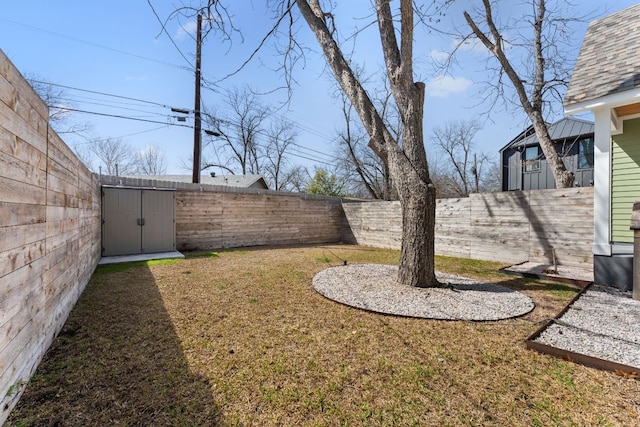 view of yard featuring a fenced backyard and an outdoor structure