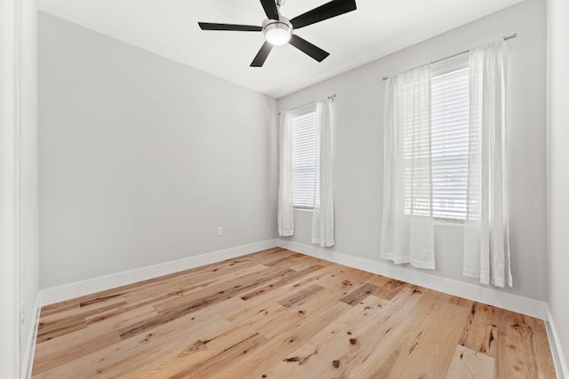 unfurnished room featuring wood finished floors, a ceiling fan, and baseboards