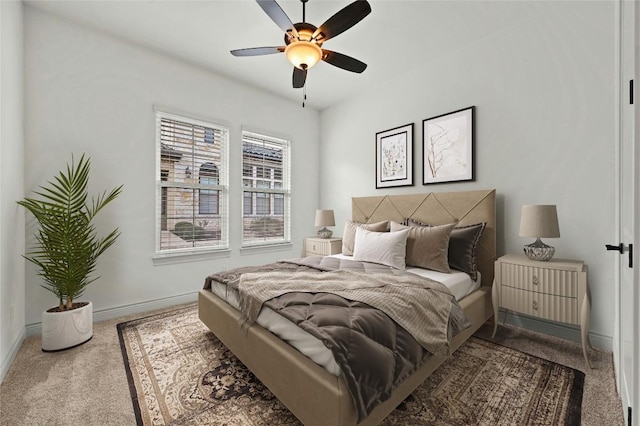 carpeted bedroom featuring a ceiling fan and baseboards