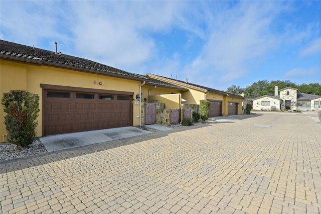 view of front of house featuring a gate and stucco siding