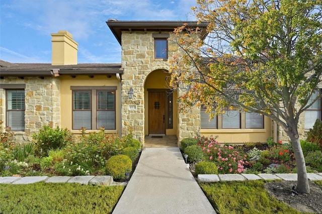 102 Gallia Dr Unit 3, Austin, TX 78734 - view of front facade featuring stone siding, a chimney, and stucco siding