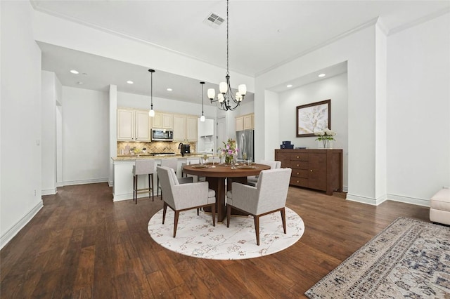 dining room with baseboards, visible vents, dark wood finished floors, and a chandelier