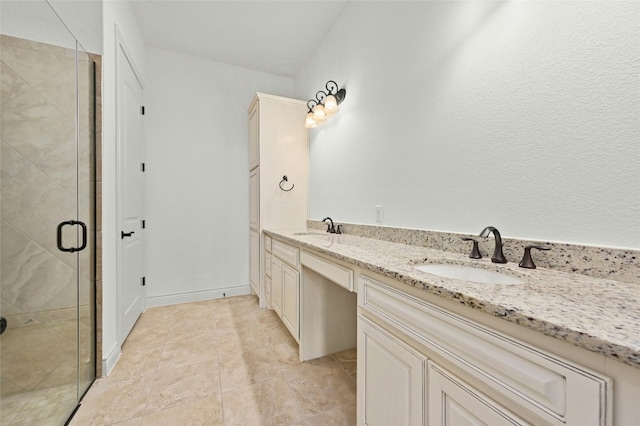 bathroom with double vanity, a stall shower, a sink, and tile patterned floors