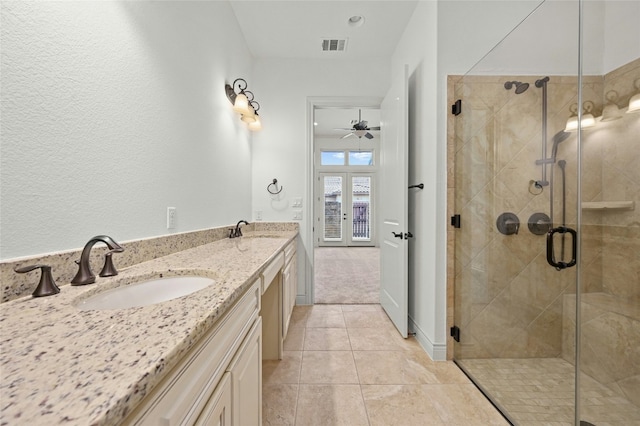 102 Gallia Dr Unit 3, Austin, TX 78734 - bathroom with double vanity, a shower stall, tile patterned flooring, and ceiling fan