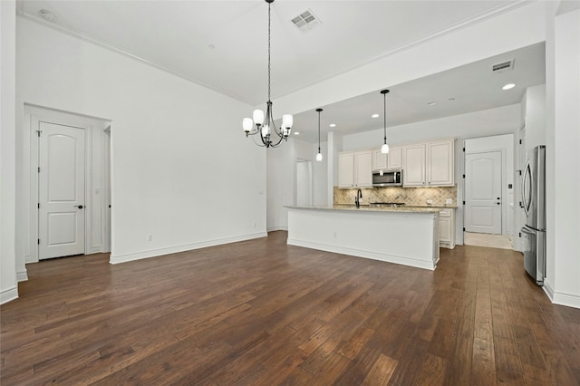 102 Gallia Dr Unit 3, Austin, TX 78734 - kitchen featuring stainless steel appliances, a chandelier, backsplash, dark wood finished floors, and open floor plan