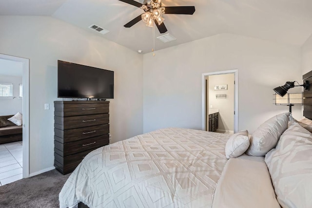 carpeted bedroom featuring lofted ceiling, ceiling fan, connected bathroom, and visible vents