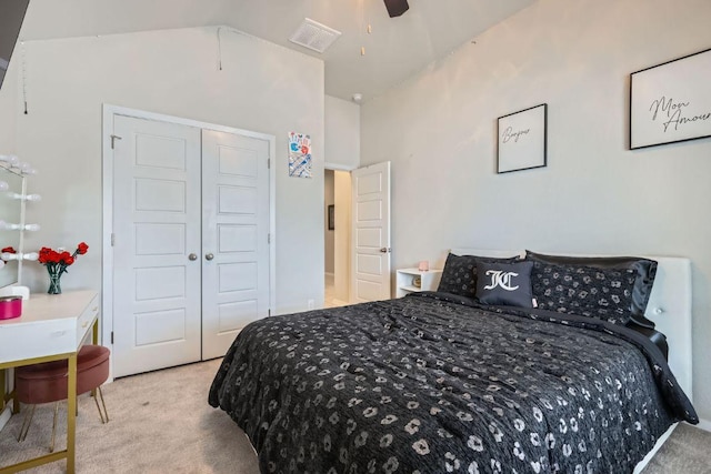 bedroom featuring a closet, visible vents, vaulted ceiling, and carpet flooring