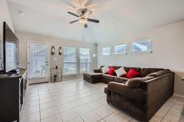 living room featuring lofted ceiling, light tile patterned flooring, a wealth of natural light, and a ceiling fan