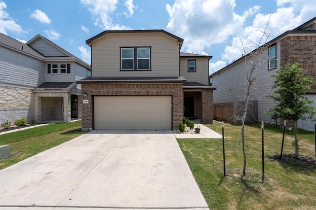 view of front facade with brick siding, a front yard, fence, a garage, and driveway