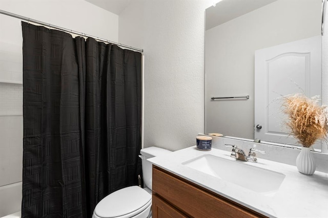 bathroom with toilet, shower / tub combo, and vanity