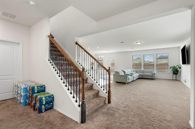 stairs featuring a chandelier, carpet, visible vents, and baseboards