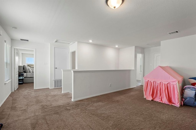 recreation room featuring recessed lighting, visible vents, and carpet flooring