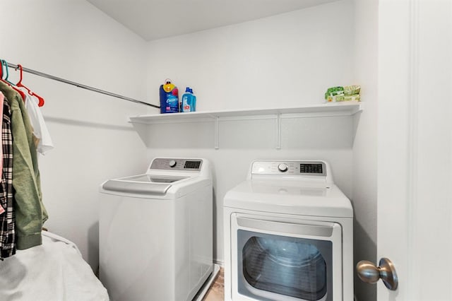 washroom featuring laundry area and separate washer and dryer