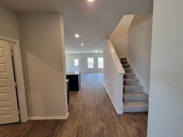 foyer with recessed lighting, dark wood finished floors, baseboards, and stairs