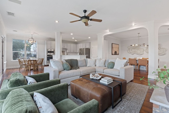 living area with baseboards, visible vents, wood finished floors, crown molding, and recessed lighting