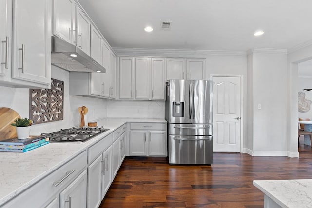 kitchen with visible vents, dark wood finished floors, ornamental molding, stainless steel appliances, and under cabinet range hood