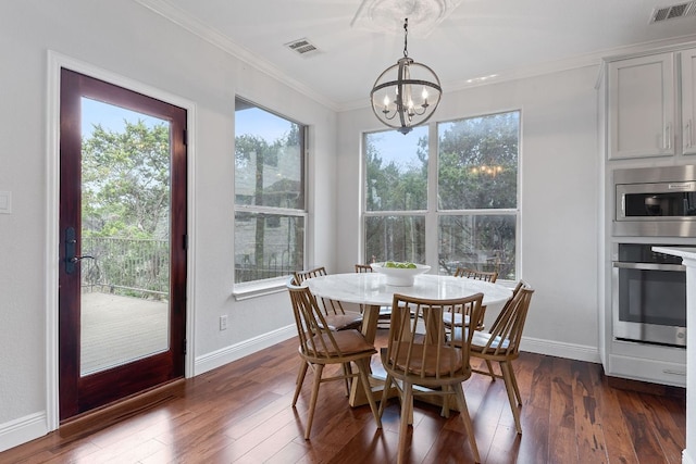 dining room with dark wood-style floors, visible vents, and crown molding