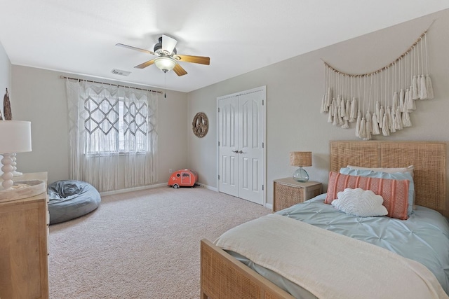 bedroom featuring a closet, visible vents, a ceiling fan, carpet flooring, and baseboards