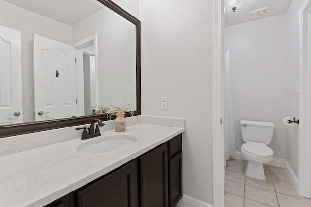 full bathroom featuring visible vents, toilet, vanity, baseboards, and tile patterned floors