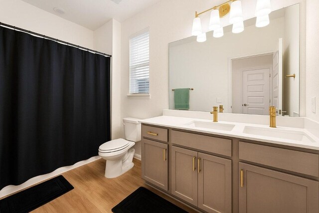 4805 Cressal Dr, Pflugerville, TX 78653 - bathroom with toilet, vanity, wood finished floors, and curtained shower