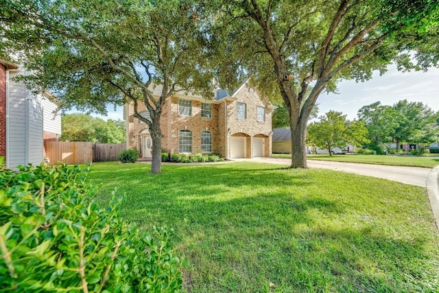 view of front of house featuring brick siding, a front yard, fence, a garage, and driveway