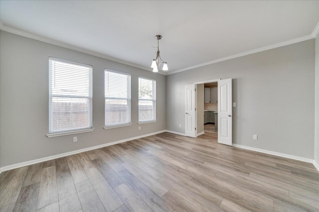 unfurnished room featuring light wood-type flooring, baseboards, and crown molding