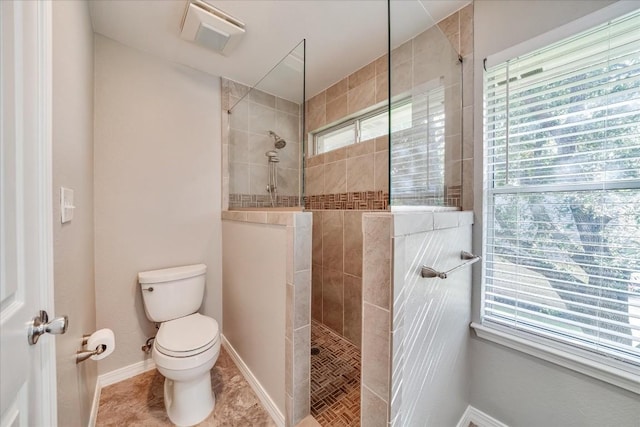 full bath with tile patterned floors, baseboards, toilet, and walk in shower