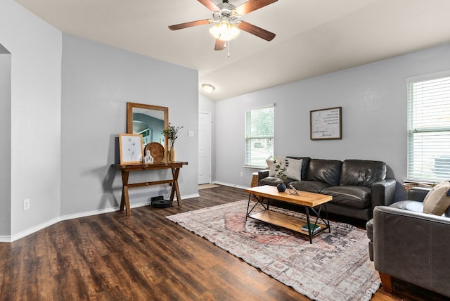 living room with lofted ceiling, ceiling fan, baseboards, and wood finished floors