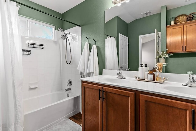 full bath featuring shower / bath combination with curtain, double vanity, a sink, and visible vents