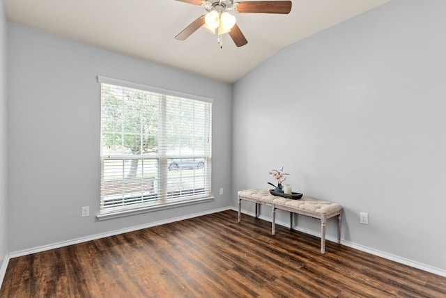 spare room with lofted ceiling, ceiling fan, wood finished floors, and baseboards