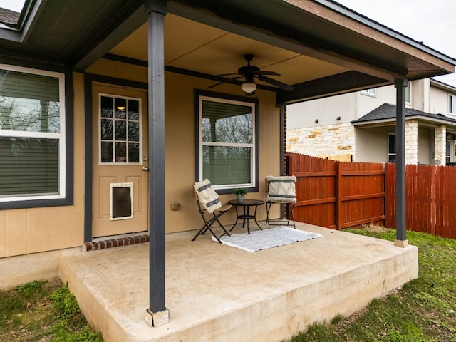 view of patio / terrace featuring ceiling fan and fence