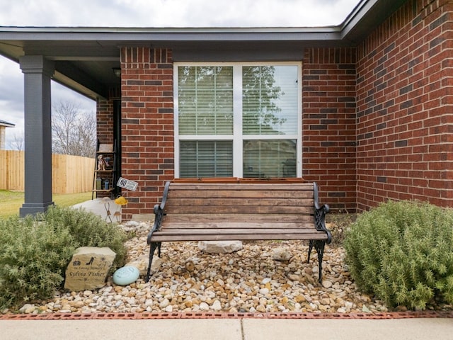 exterior space with brick siding and fence