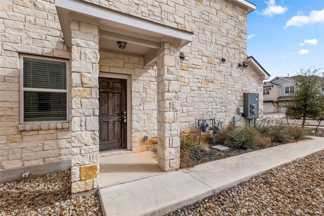 doorway to property with stone siding