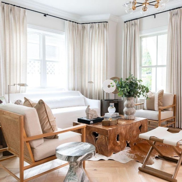 living area featuring ornamental molding and a chandelier