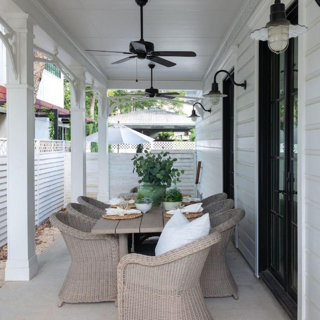 view of patio featuring ceiling fan and fence