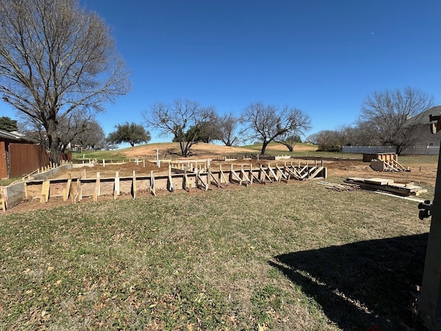 view of yard with a vegetable garden and fence