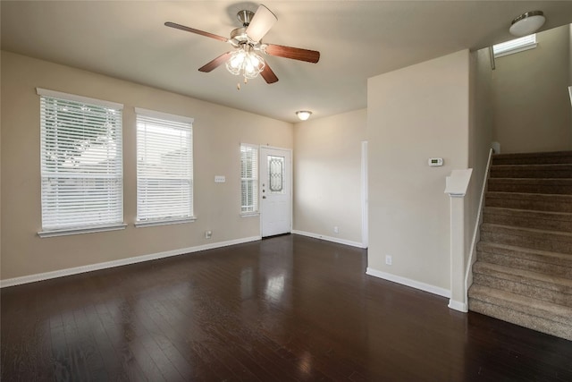 foyer entrance featuring stairs, wood finished floors, baseboards, and a ceiling fan