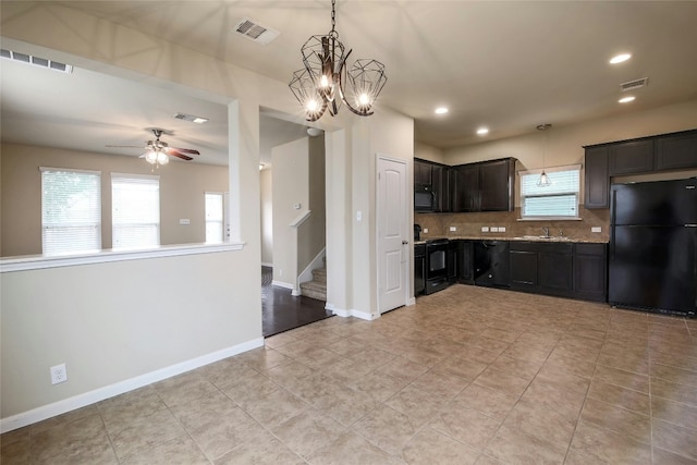 kitchen featuring visible vents, baseboards, tasteful backsplash, and black appliances