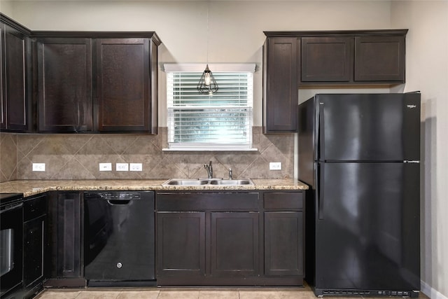 kitchen with black appliances, a sink, backsplash, dark brown cabinetry, and light stone countertops