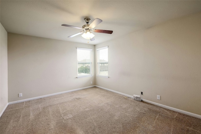 unfurnished room featuring baseboards, carpet, and a ceiling fan