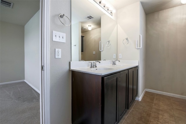 bathroom with a sink, visible vents, and baseboards