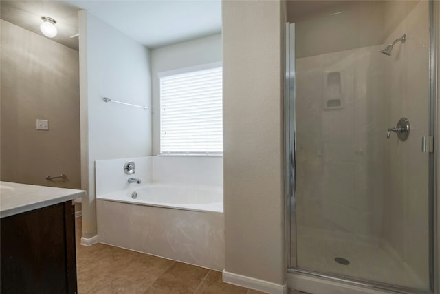 bathroom with vanity, a garden tub, a stall shower, and tile patterned floors