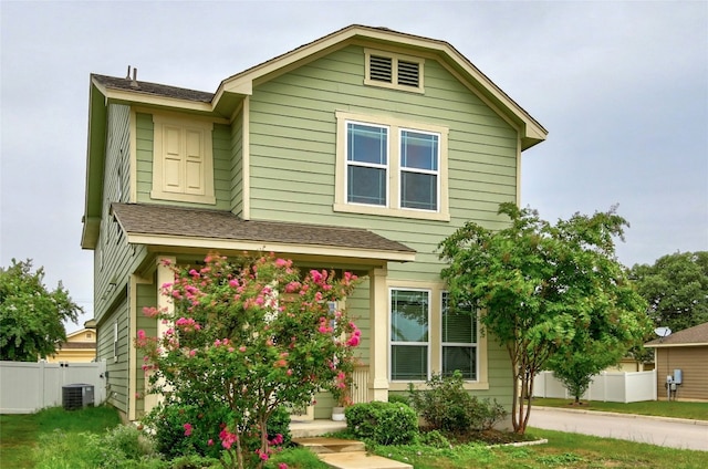 view of front of house with cooling unit and fence