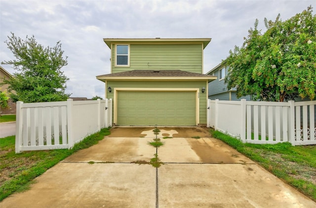 view of front facade featuring concrete driveway and fence