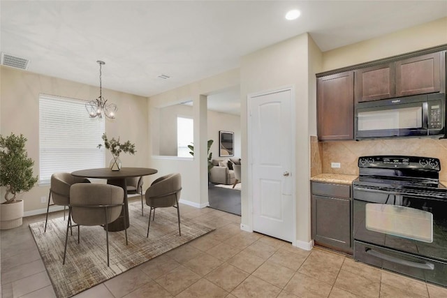 kitchen featuring visible vents, black appliances, backsplash, dark brown cabinetry, and light countertops